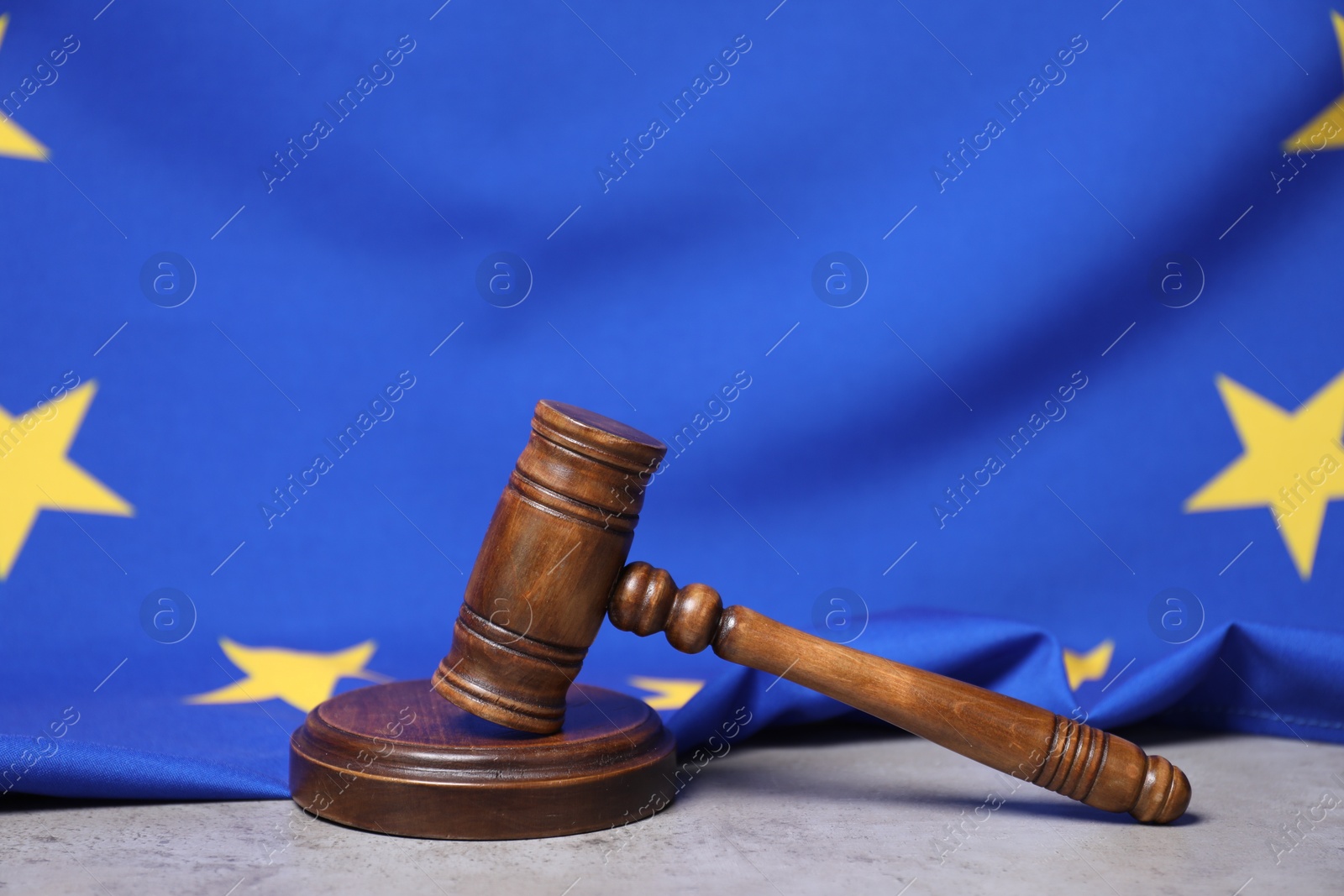 Photo of Judge's gavel and European Union flag on grey table