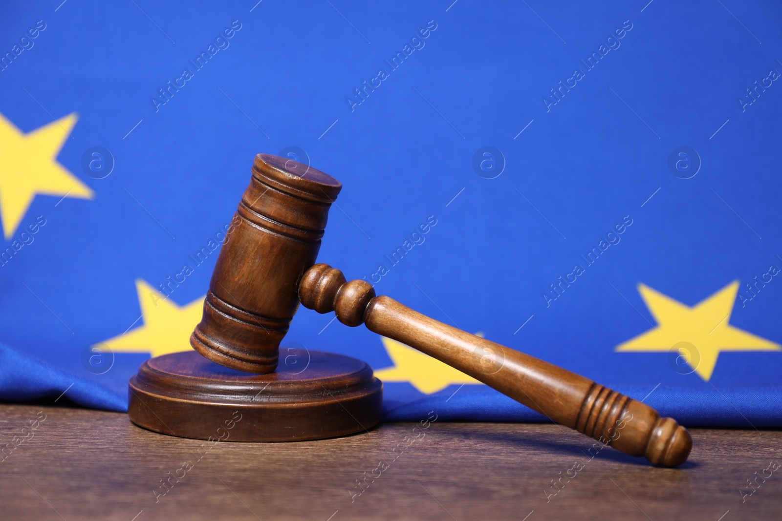 Photo of Judge's gavel and European Union flag on wooden table