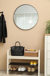 Mirror and shoe storage bench in hallway. Interior design