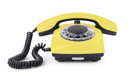 Image of Old yellow telephone with rotary dial isolated on white