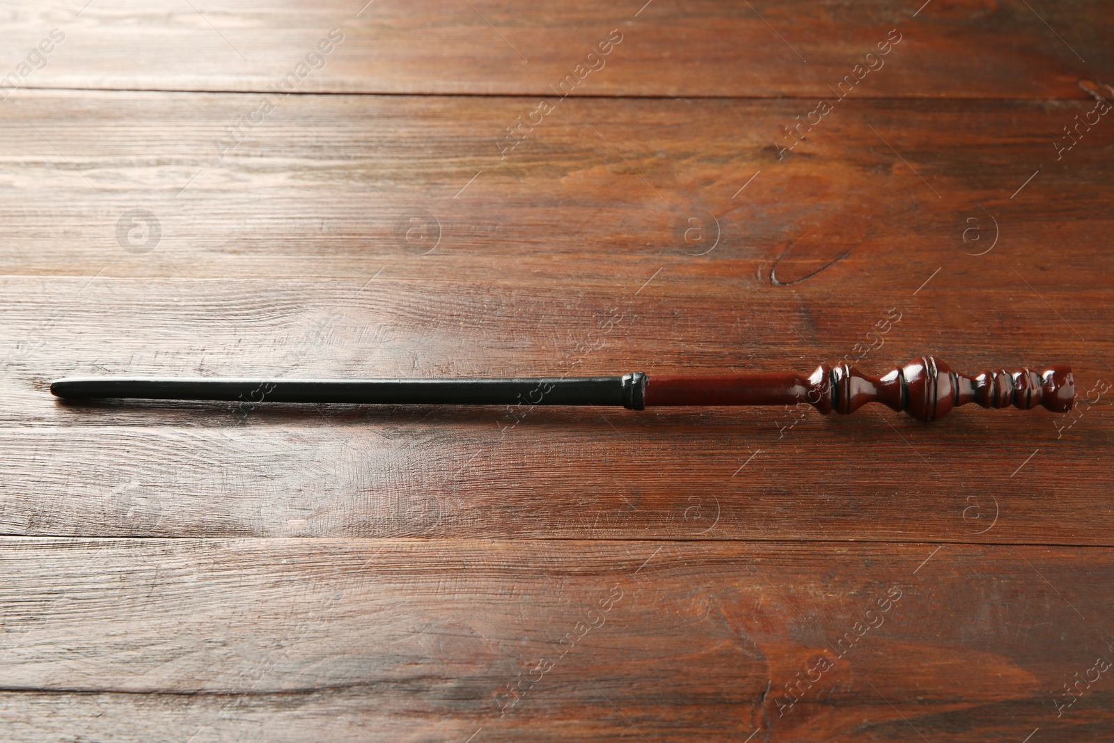 Photo of One old magic wand on wooden table