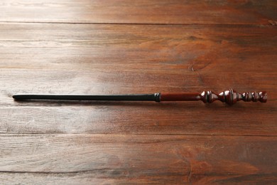 Photo of One old magic wand on wooden table