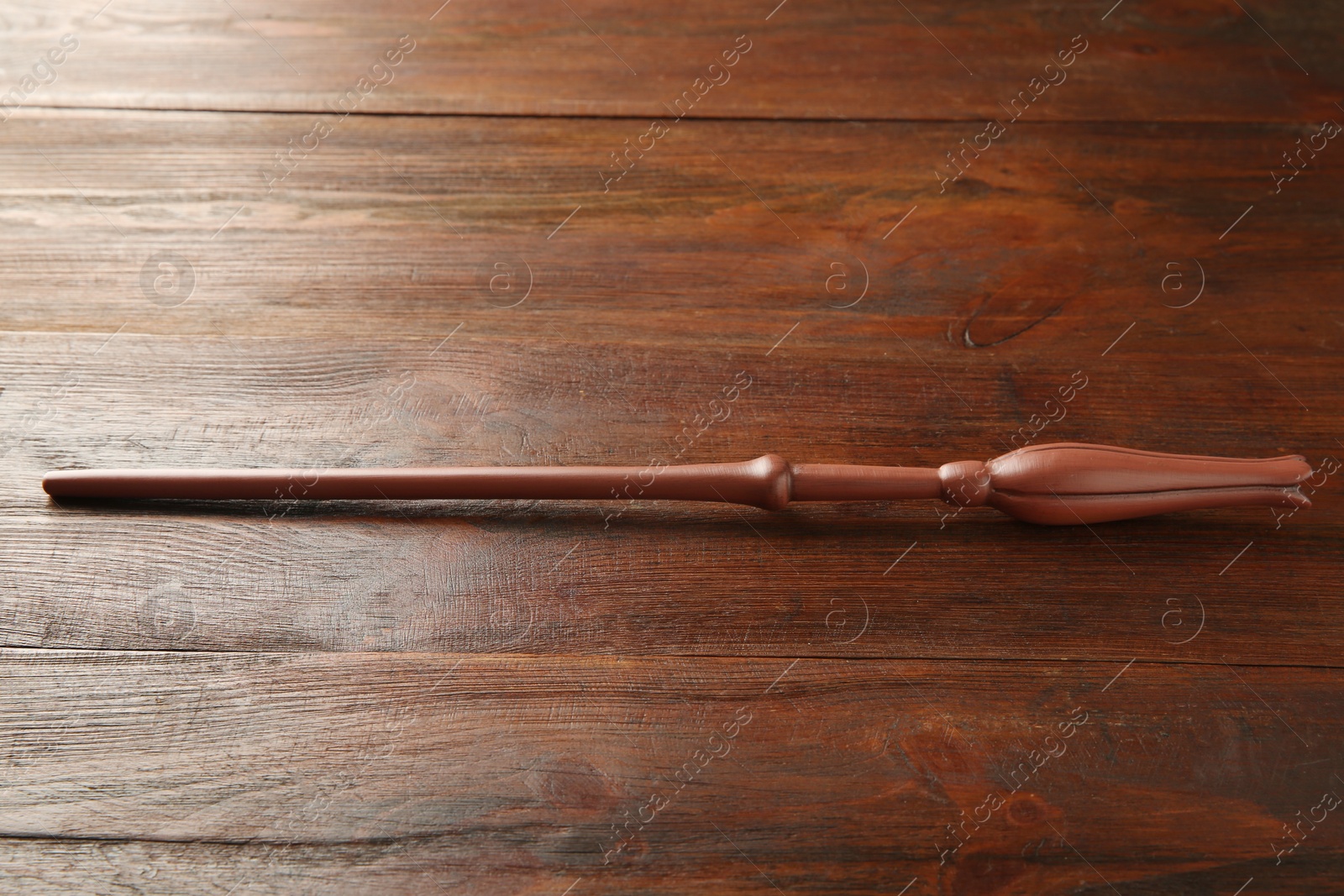 Photo of One old magic wand on wooden table