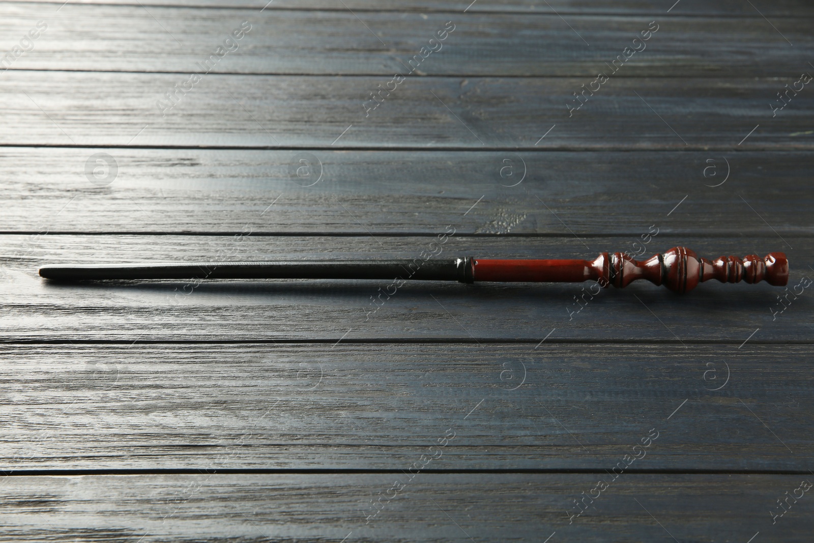 Photo of One old magic wand on wooden table