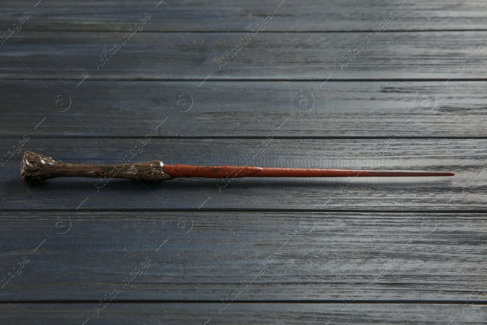 Photo of One old magic wand on wooden table