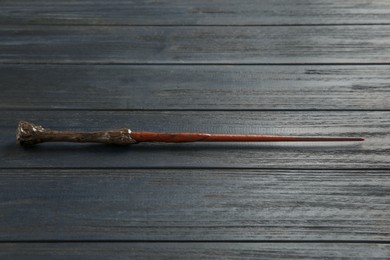 Photo of One old magic wand on wooden table