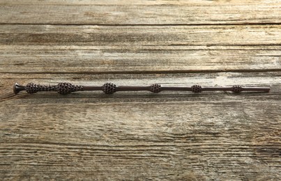 Photo of One old magic wand on wooden table