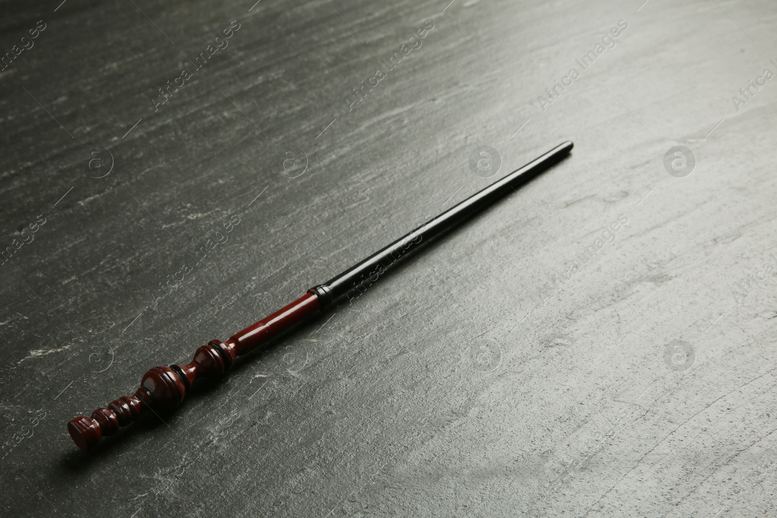 Photo of One old magic wand on black table