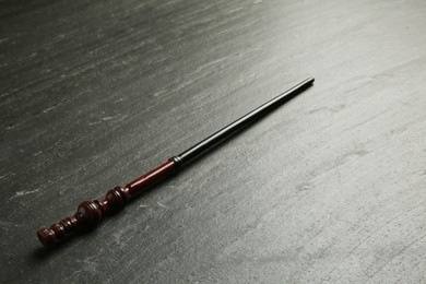 Photo of One old magic wand on black table