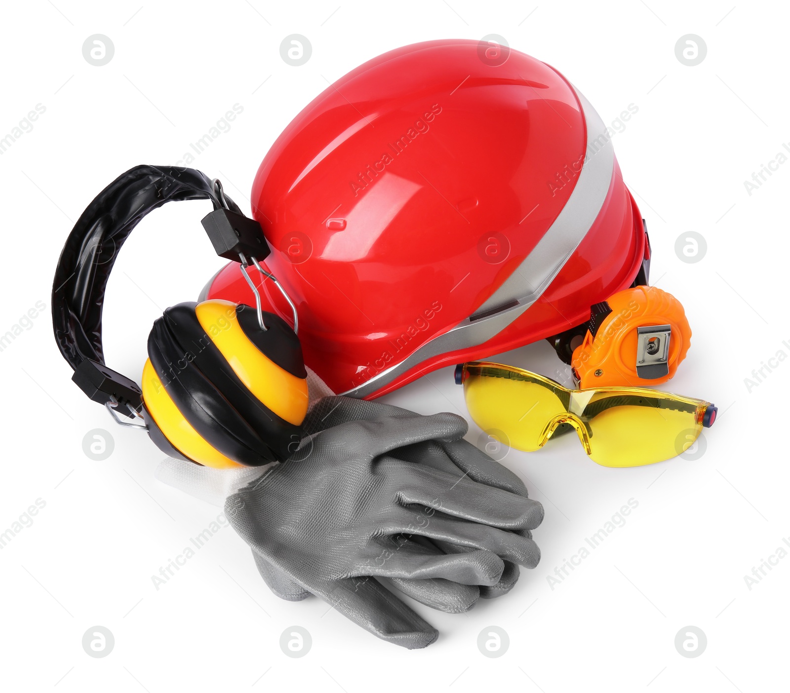 Photo of Orange hard hat, earmuffs, goggles, gloves and measuring tape isolated on white. Construction tools