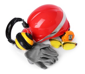 Photo of Orange hard hat, earmuffs, goggles, gloves and measuring tape isolated on white. Construction tools