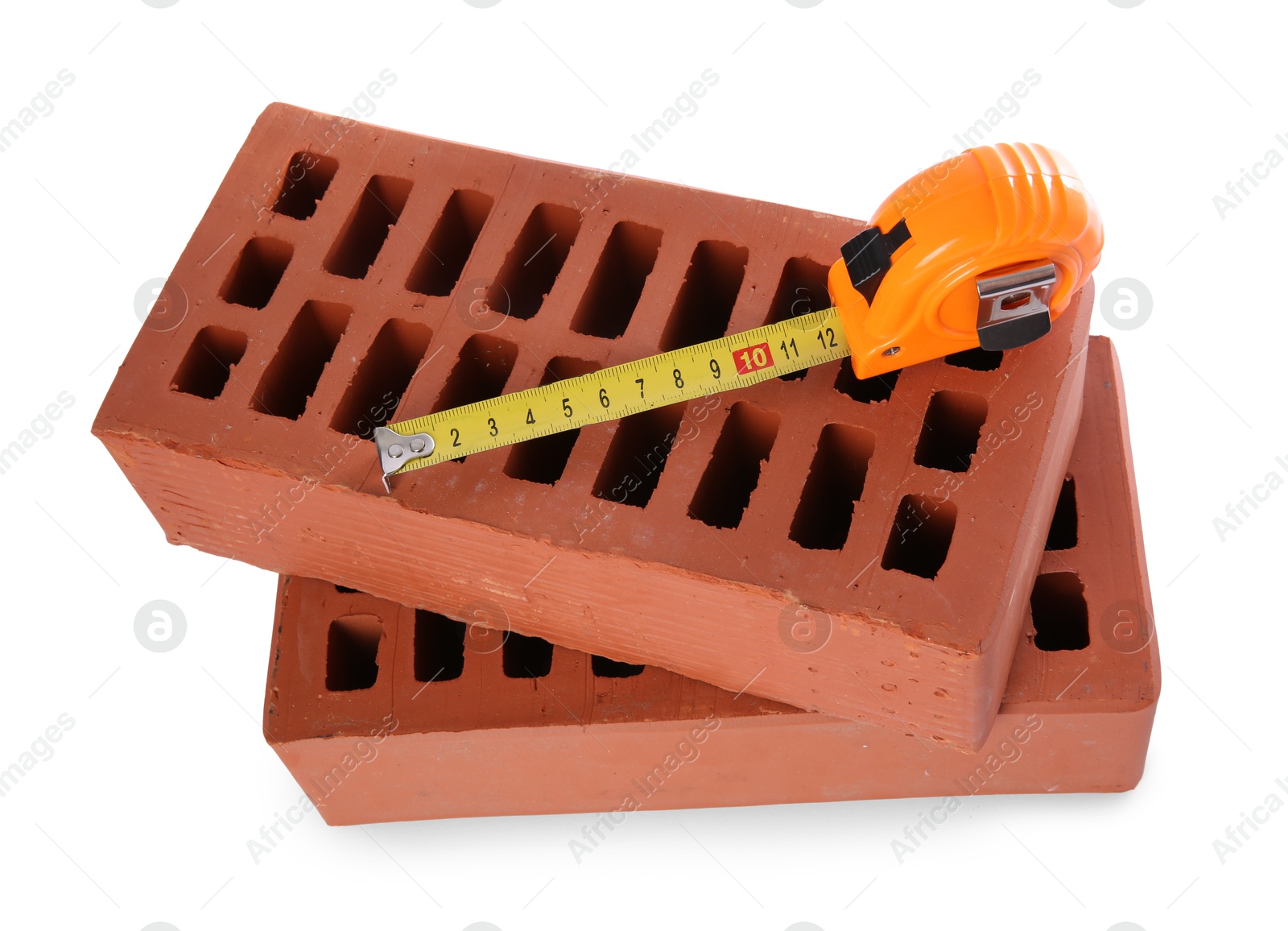 Photo of Red bricks and measuring tape isolated on white. Construction tools