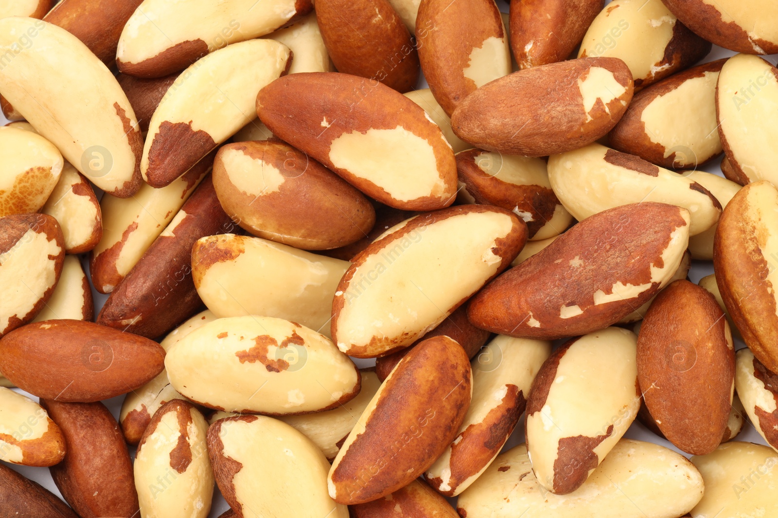 Photo of Tasty Brazil nuts as background, top view