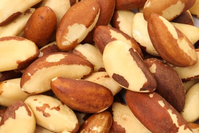 Photo of Tasty Brazil nuts as background, top view