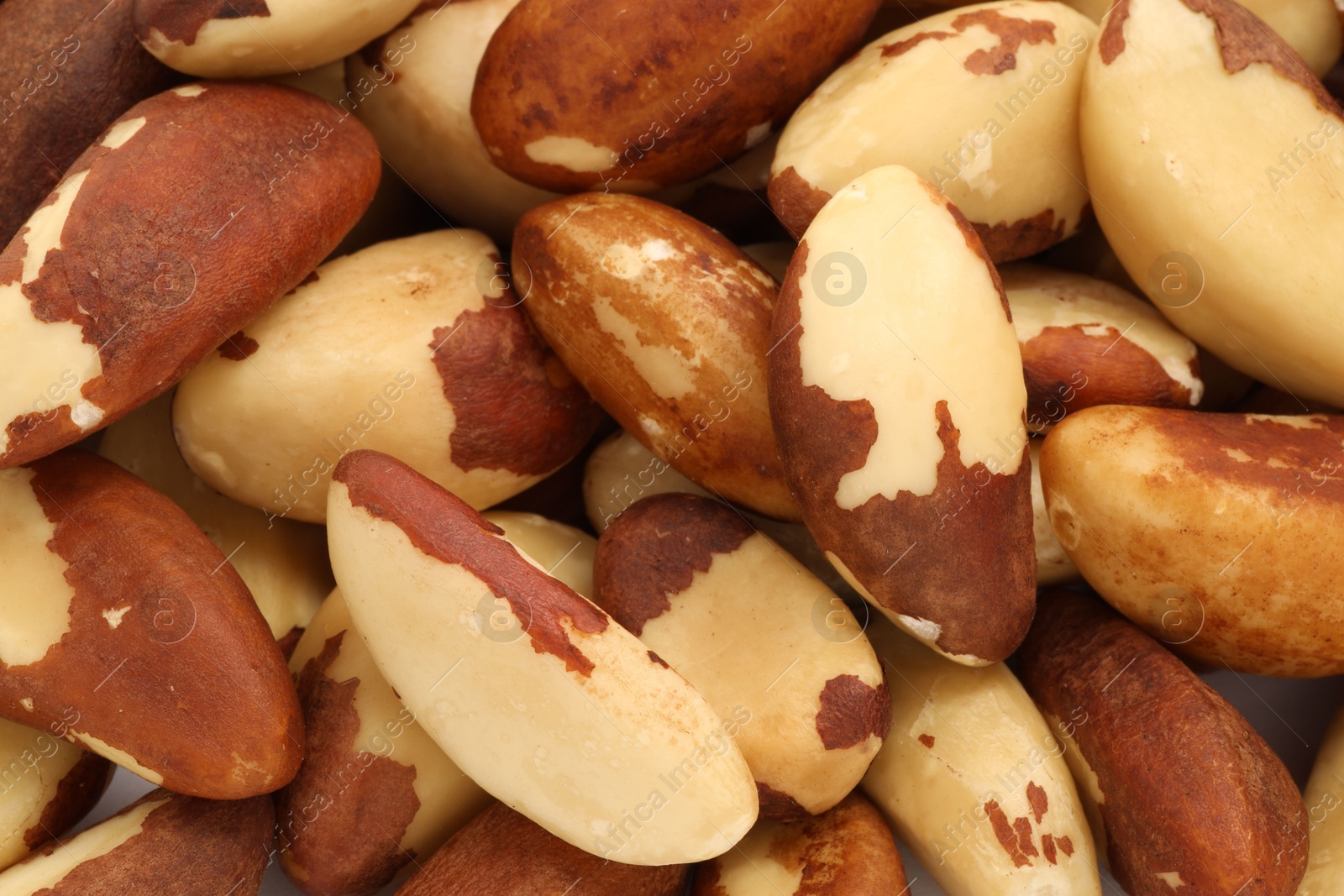 Photo of Tasty Brazil nuts as background, top view