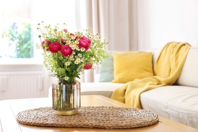 Photo of Beautiful ranunculus flowers and chamomiles in vase on table indoors. Space for text