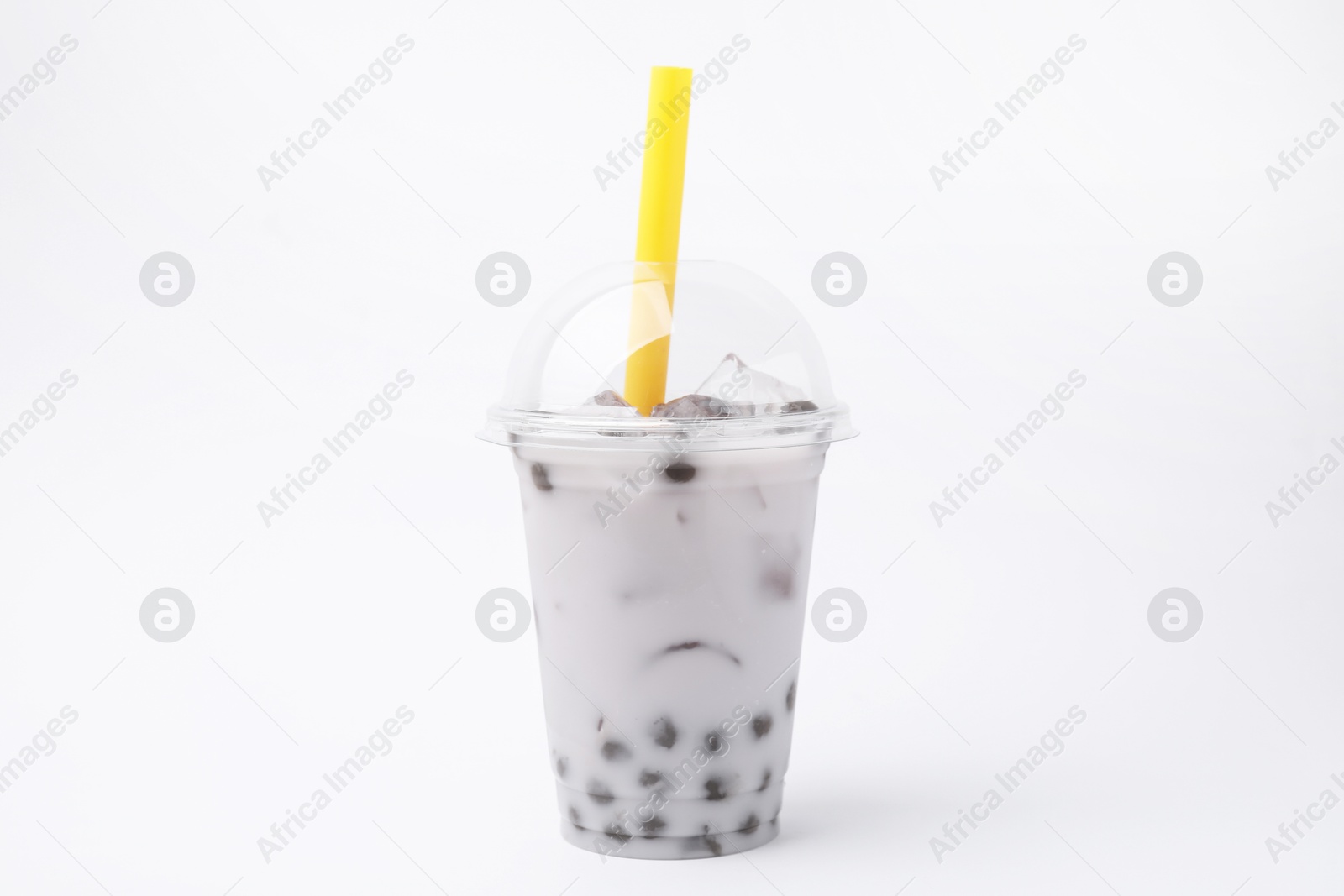 Photo of Tasty milk bubble tea in plastic cup on white background