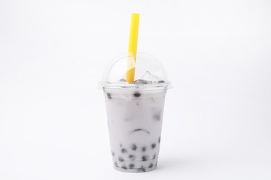 Photo of Tasty milk bubble tea in plastic cup on white background