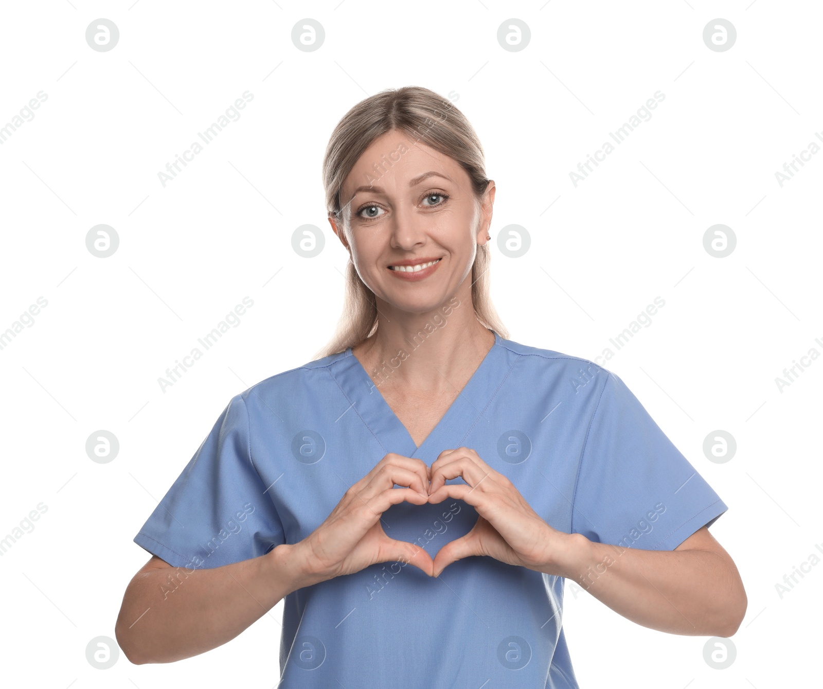 Photo of Nurse in medical uniform making heart with her hands on white background