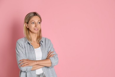 Photo of Beautiful smiling woman on pink background, space for text