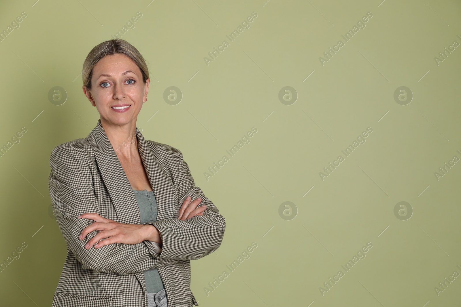 Photo of Portrait of beautiful smiling woman on olive background, space for text