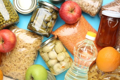 Photo of Food donation. Different products on light blue background, top view