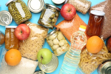 Photo of Food donation. Different products on light blue background, top view