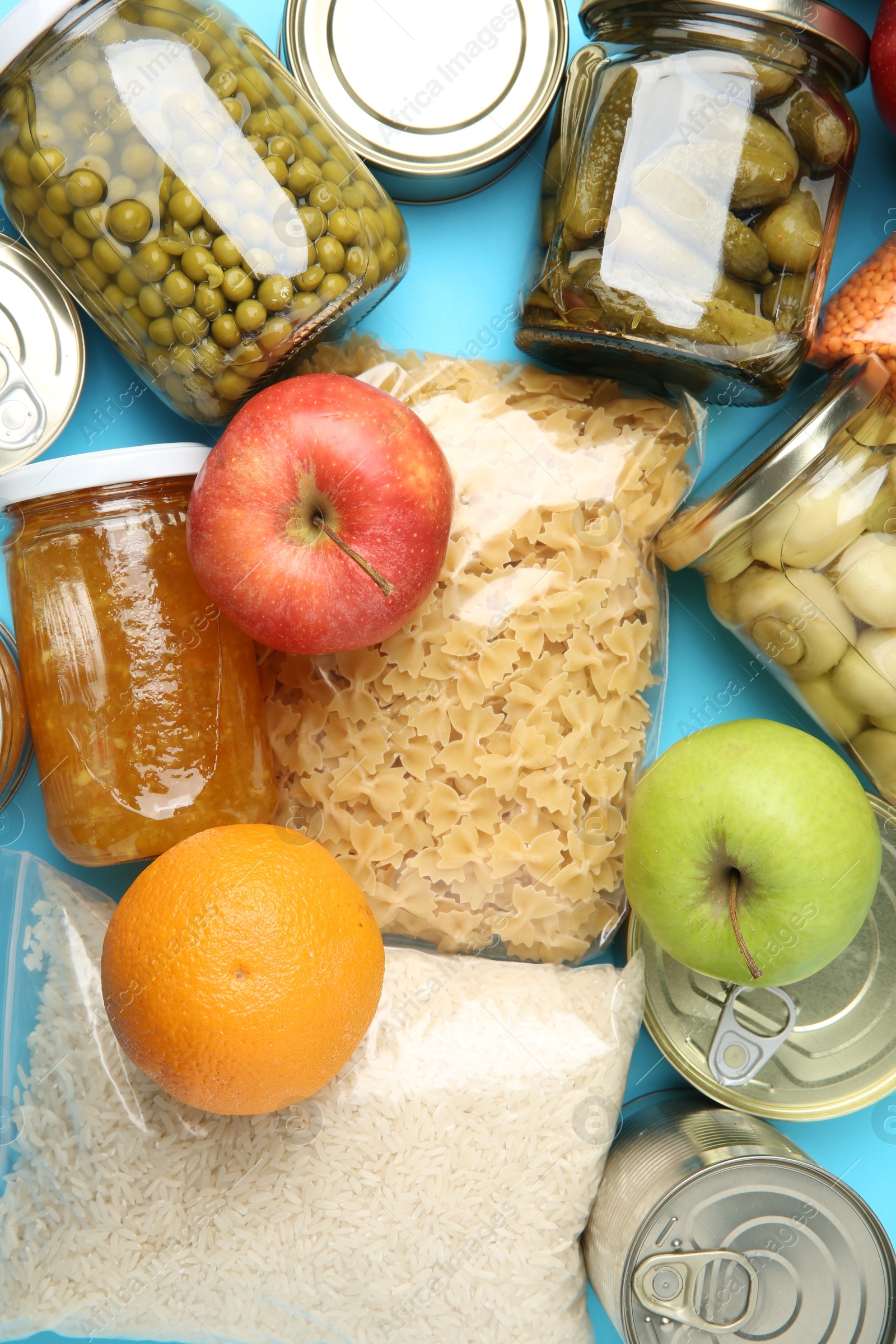 Photo of Food donation. Different products on light blue background, top view