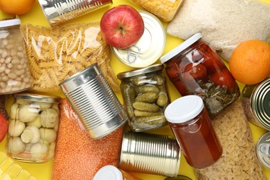 Photo of Food donation. Different products on yellow background, top view