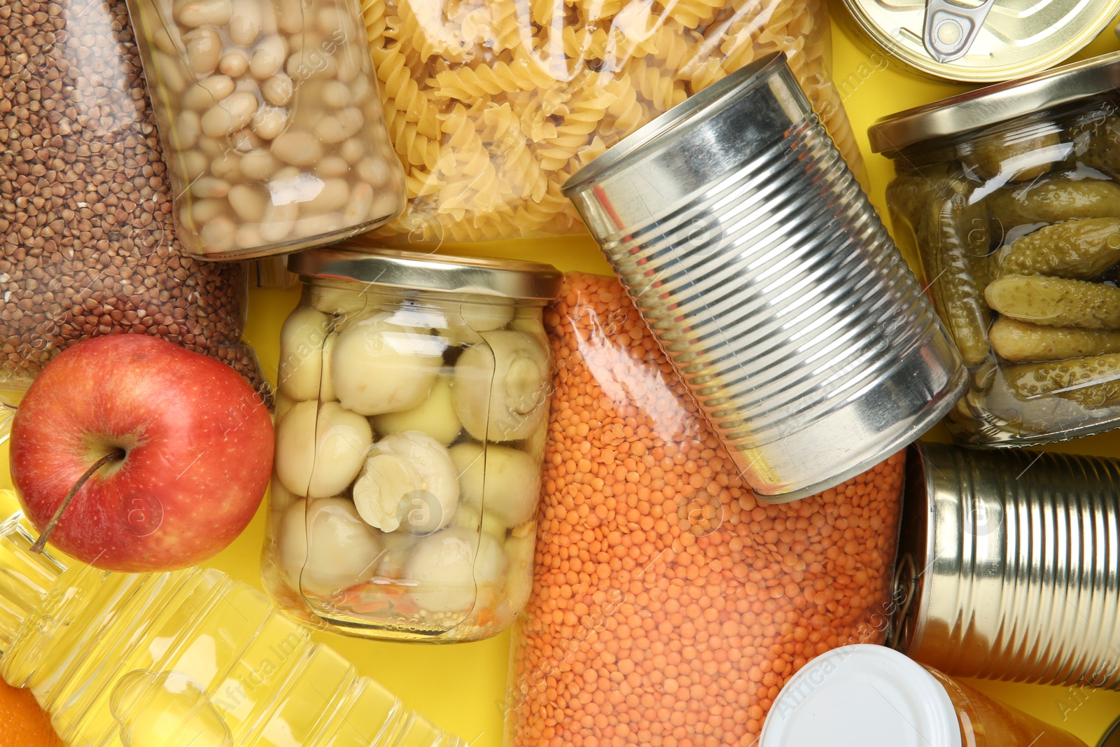 Photo of Food donation. Different products on yellow background, top view