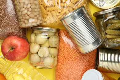 Photo of Food donation. Different products on yellow background, top view