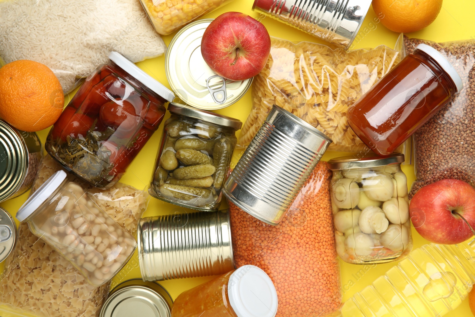 Photo of Food donation. Different products on yellow background, top view