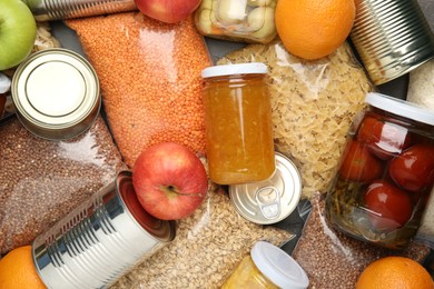 Photo of Food donation. Different products on table, top view