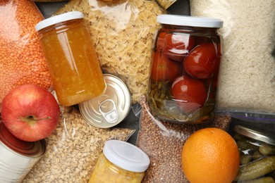 Photo of Food donation. Different products on table, top view