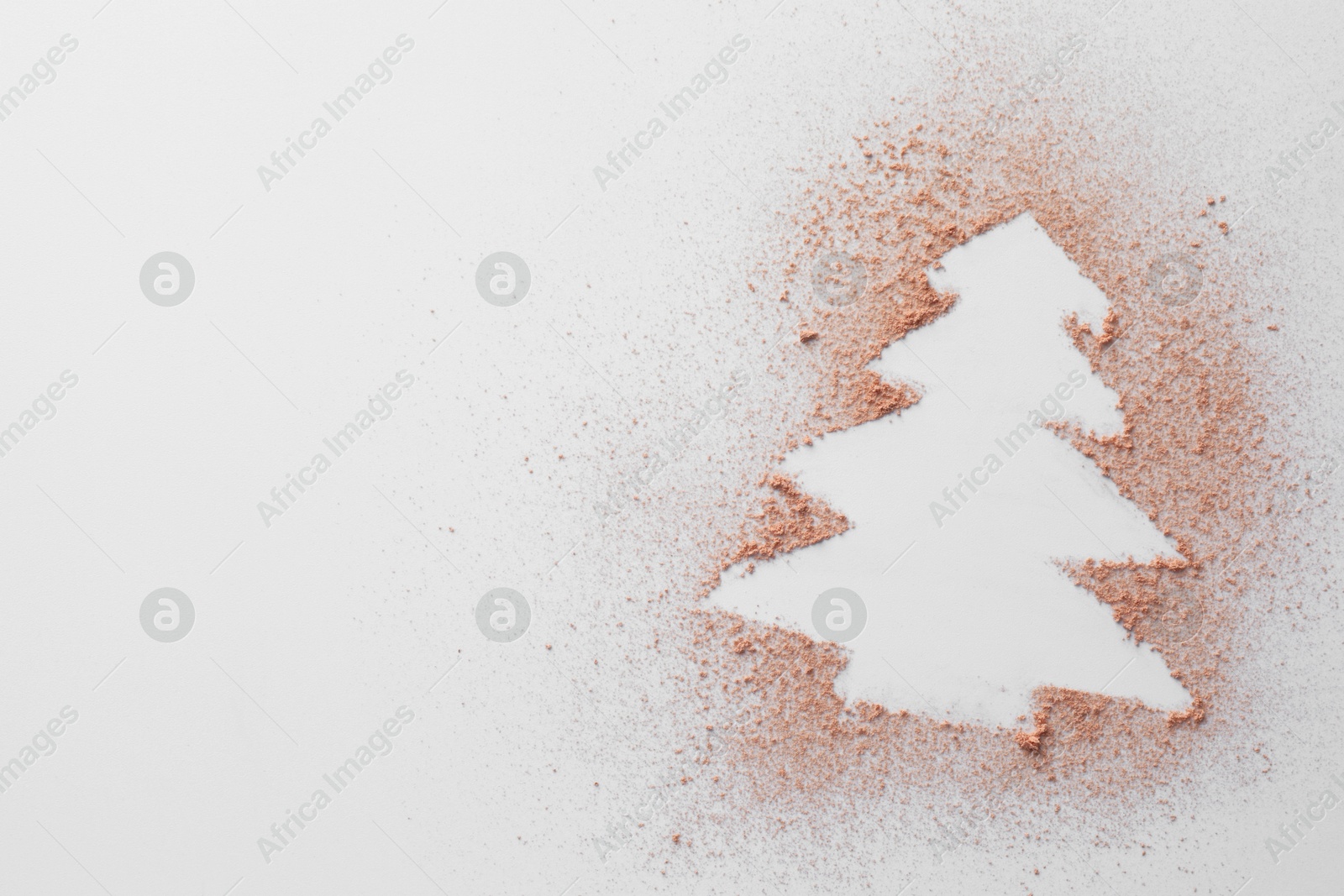 Photo of Christmas tree made of powder on white background, top view. Space for text