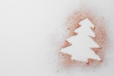 Photo of Christmas tree made of powder on white background, top view. Space for text