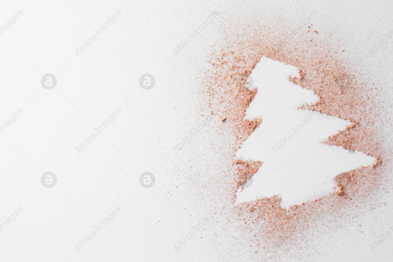 Photo of Christmas tree made of powder on white background, top view. Space for text