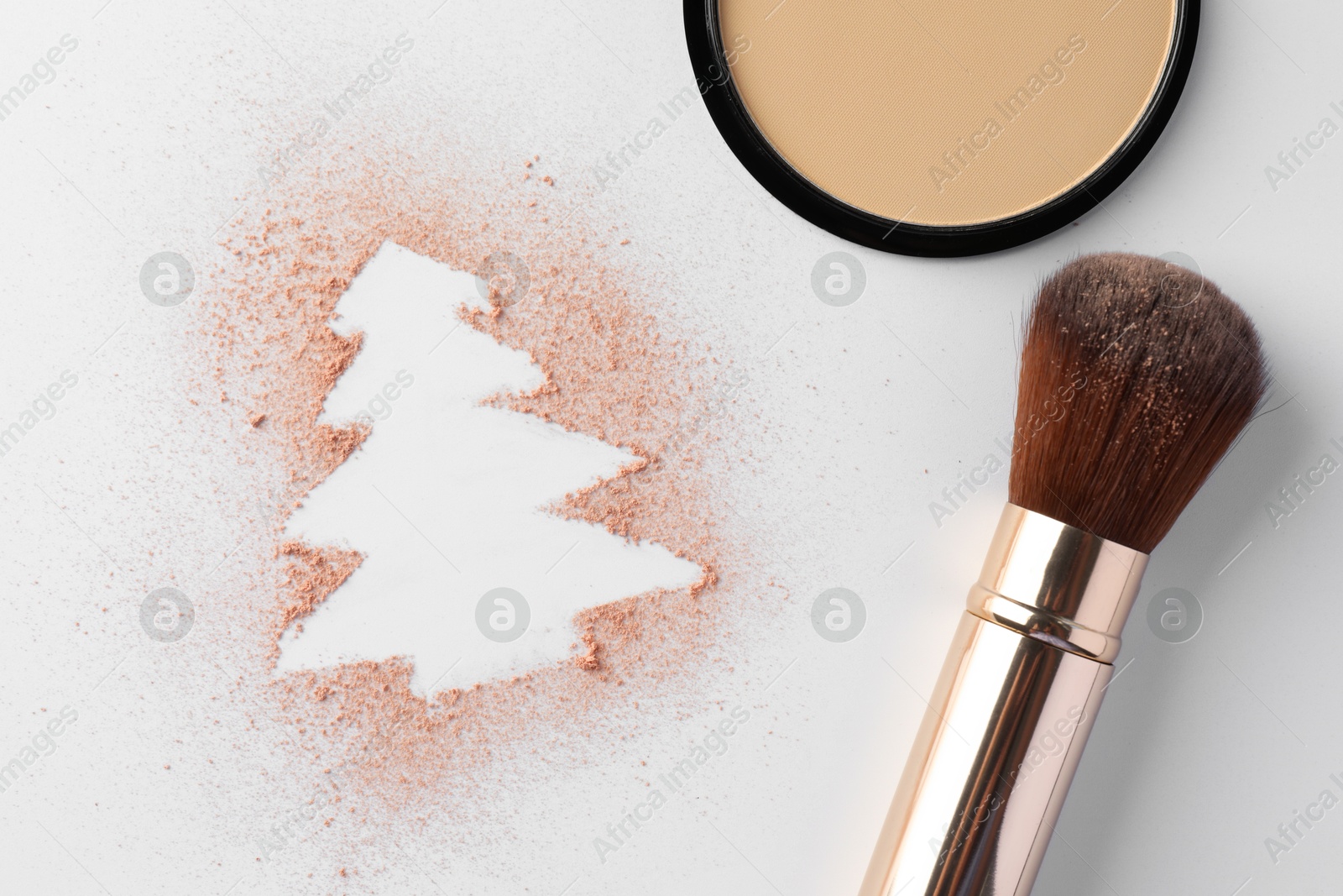 Photo of Christmas tree made of powder and makeup brush on white background, flat lay