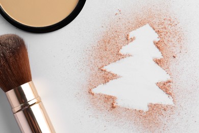 Photo of Christmas tree made of powder and makeup brush on white background, flat lay