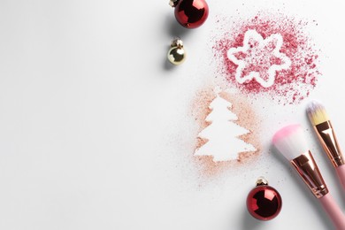 Photo of Christmas decorations made of powder and blush, balls and makeup brushes on white background, flat lay. Space for text