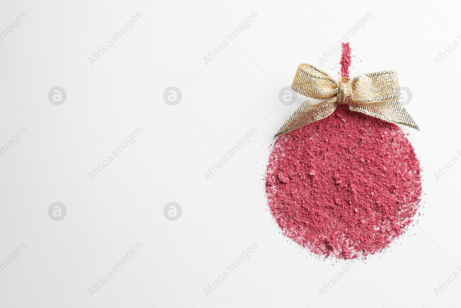 Photo of Christmas ball made of blush with bow on white background, top view. Space for text