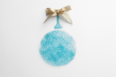 Photo of Christmas ball made of light blue glitter with bow on white background, top view