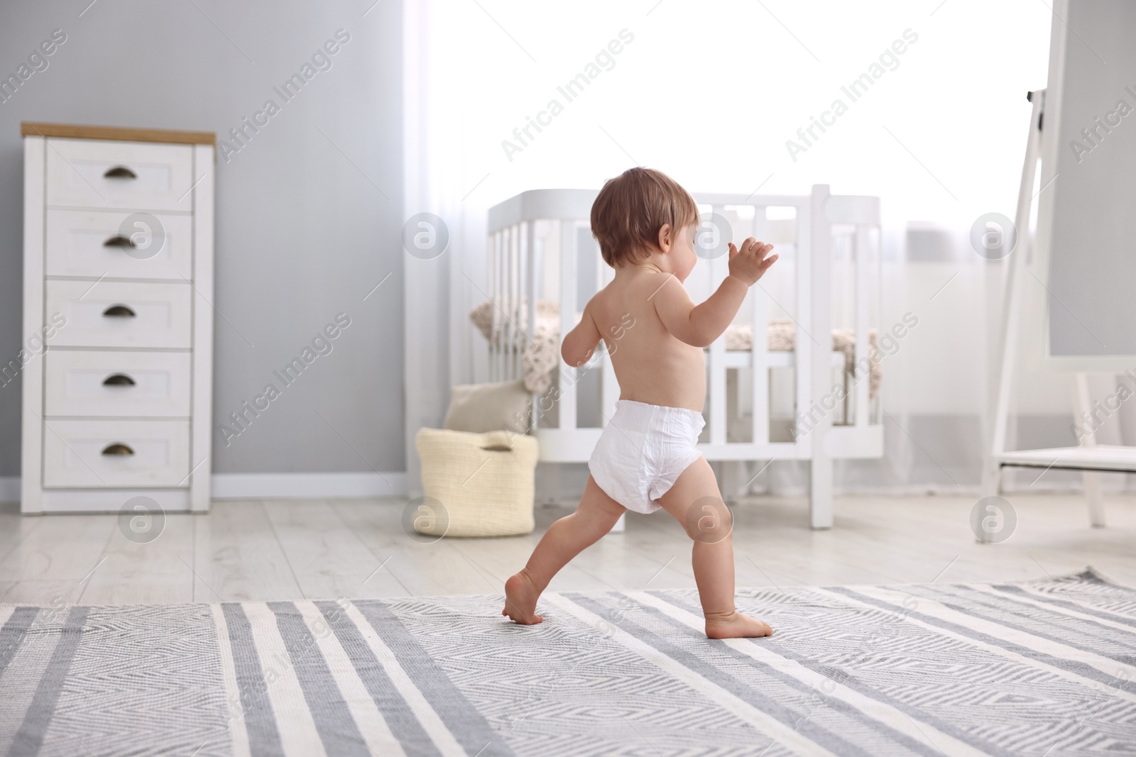 Photo of Cute little child in diaper at home