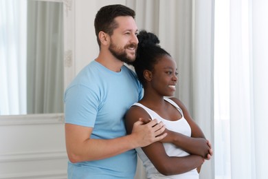 International relationships. Portrait of lovely couple at home