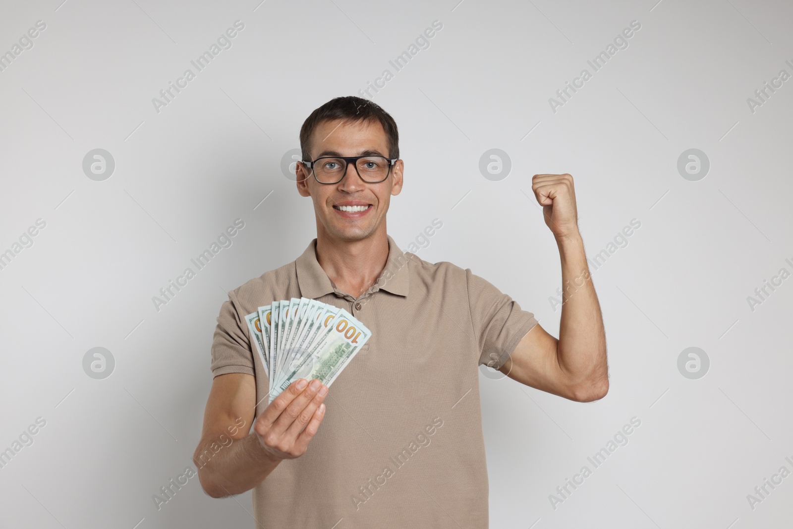 Photo of Man with dollar banknotes on white background