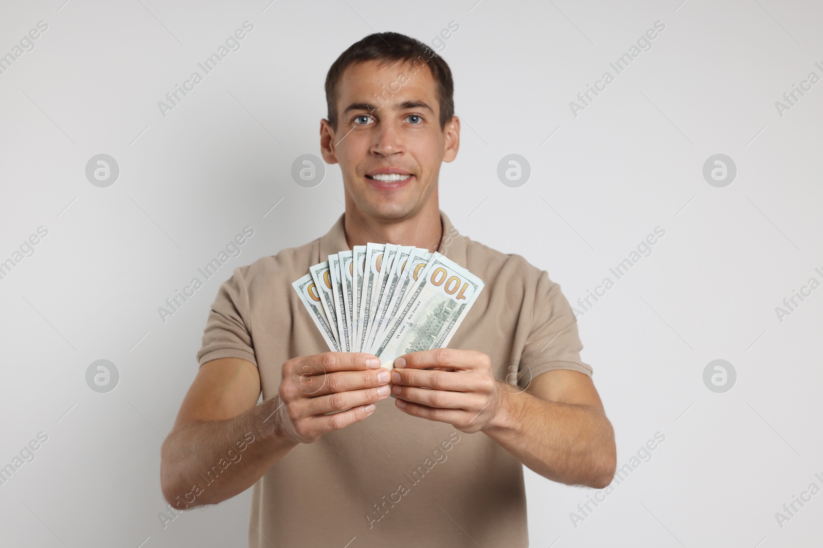 Photo of Man with dollar banknotes on white background