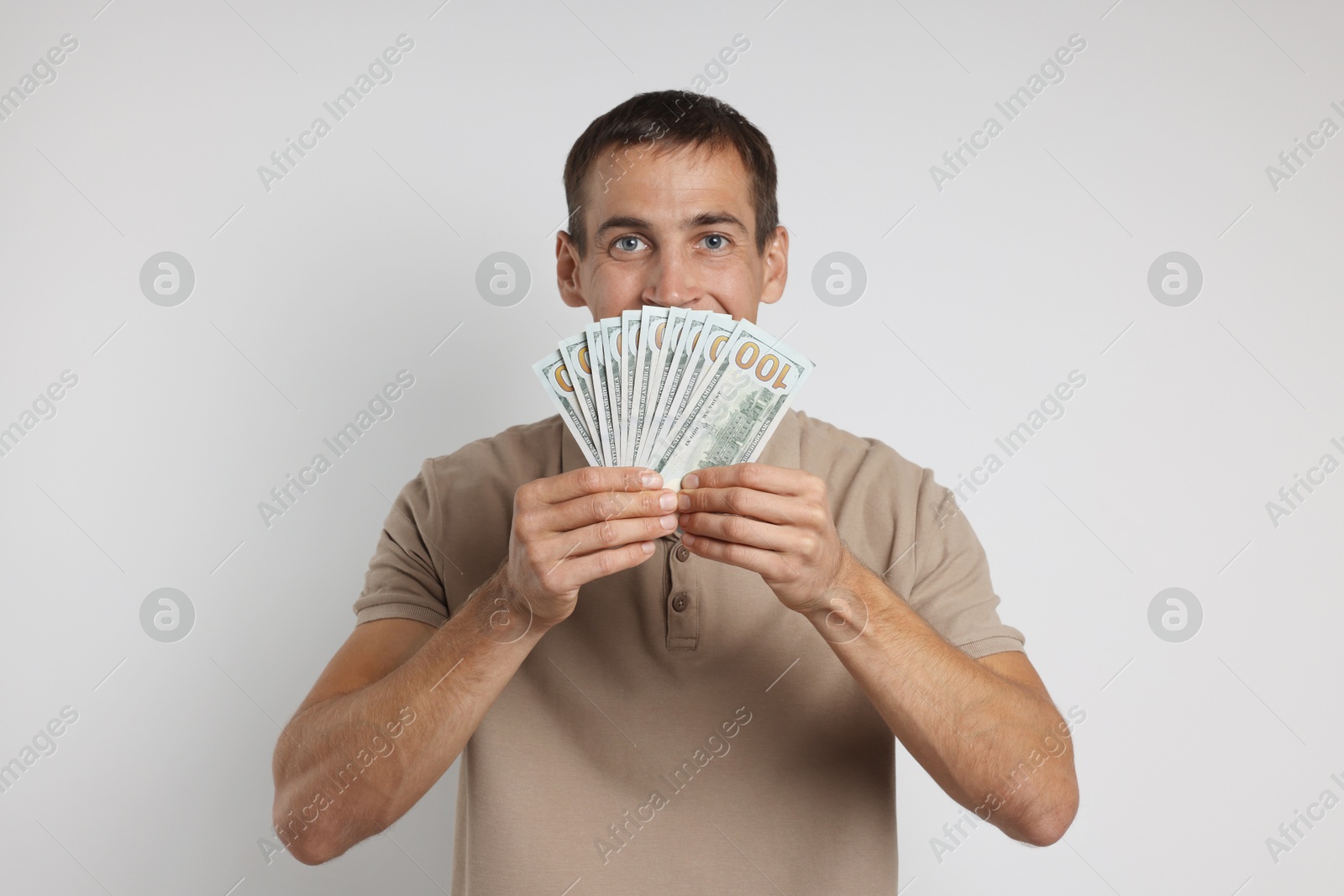 Photo of Man with dollar banknotes on white background