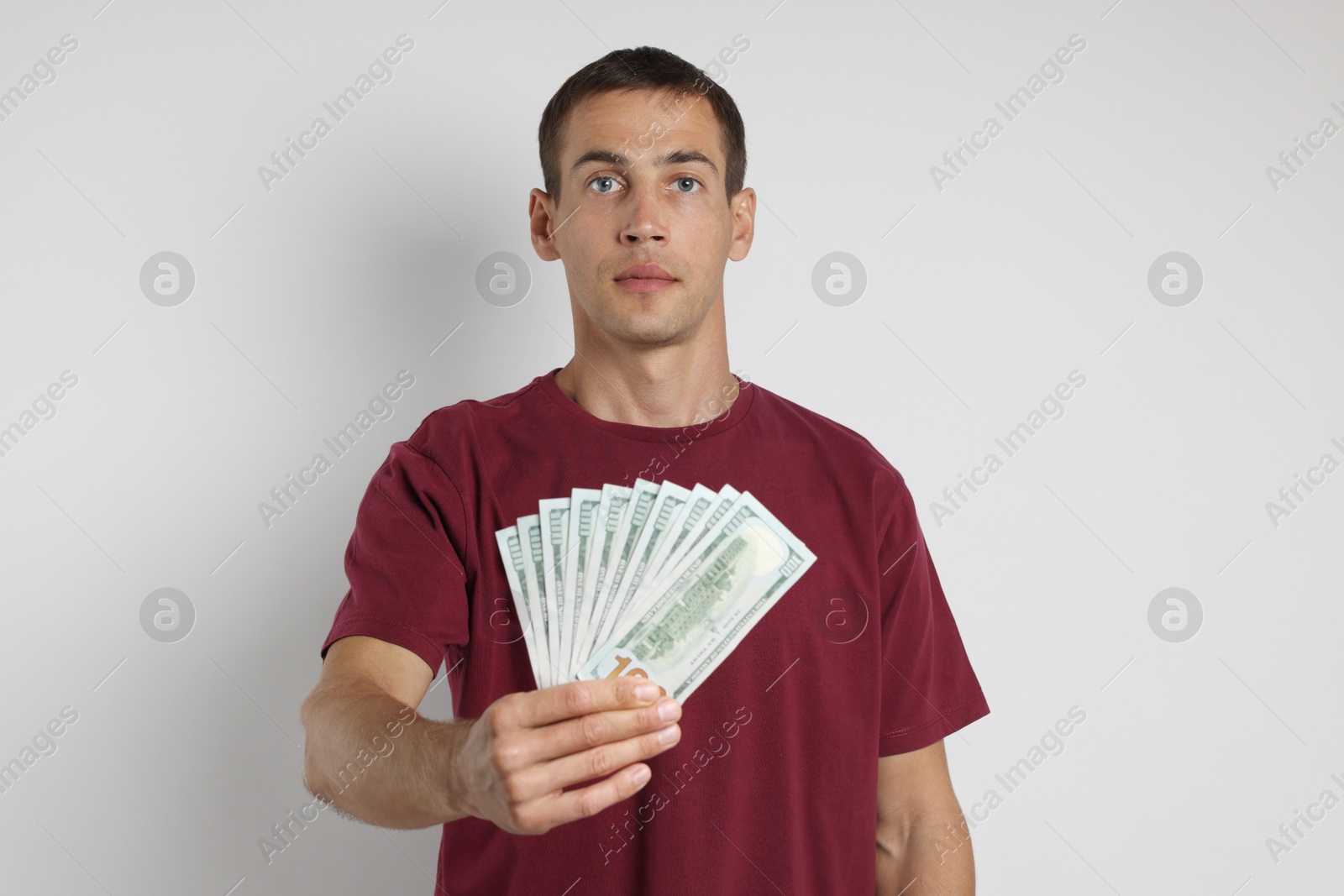 Photo of Man with dollar banknotes on white background