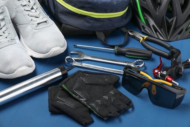 Bicycle accessories and tools on blue wooden table