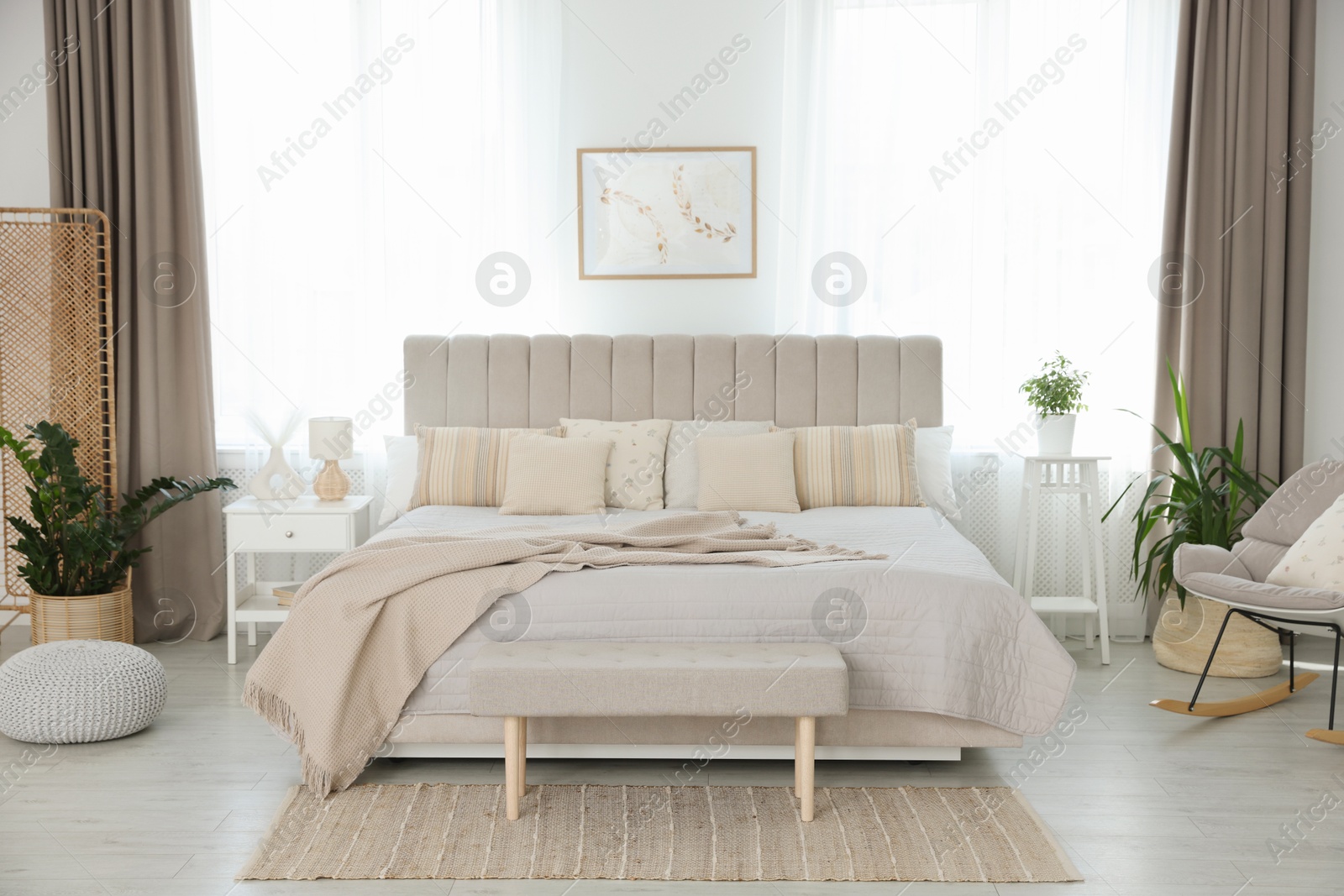 Photo of Big comfortable bed in room. Interior design